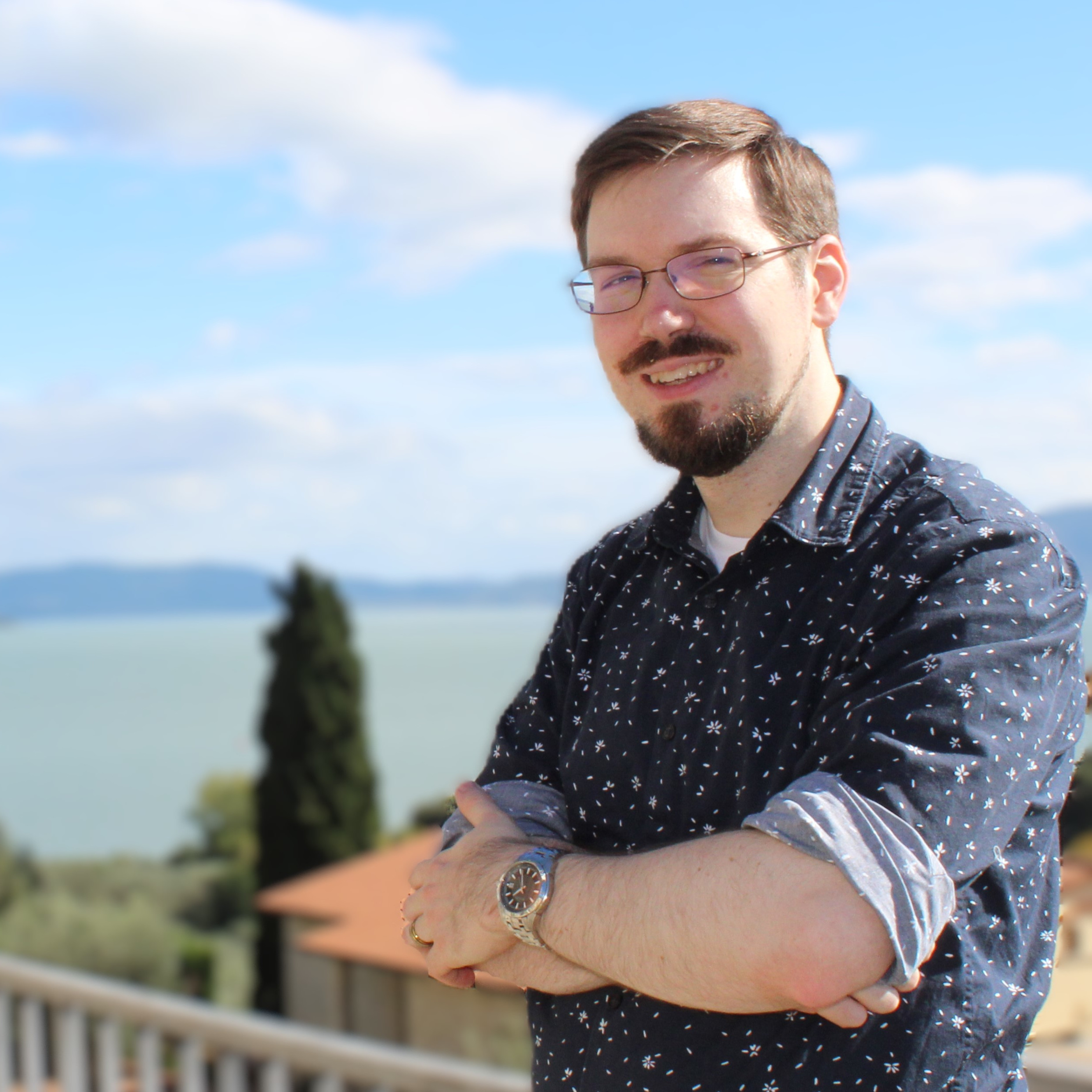 A photo of Justin Groves overlooking a lake.